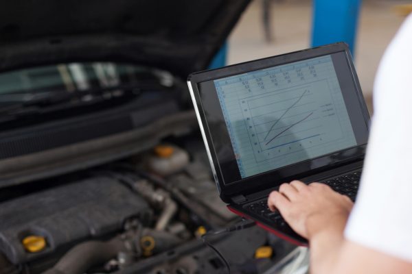 Man testing an engine with computer